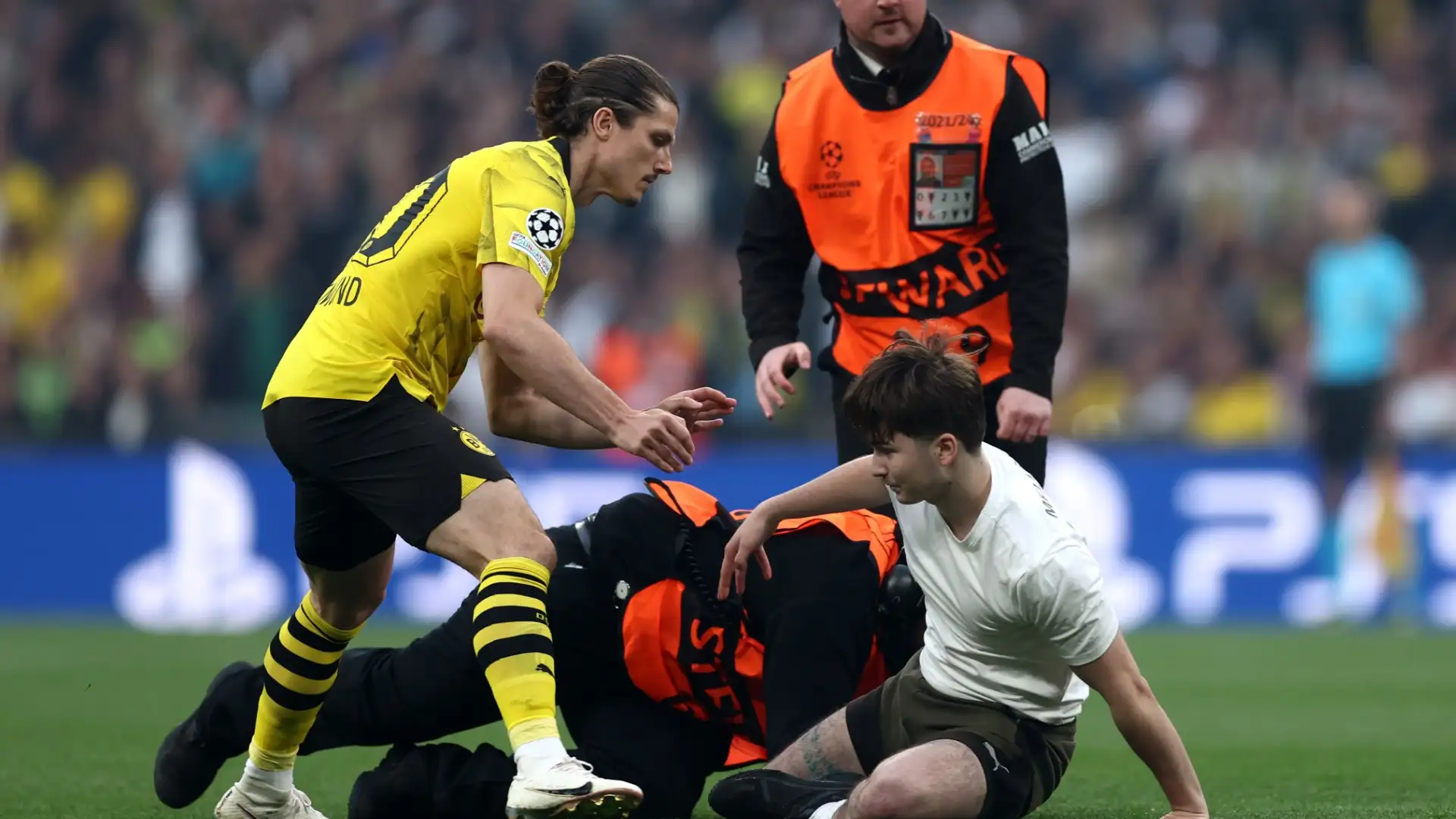 ‘This is some bullsh*t’ – Fans go wild as Champions League final disrupted after 30 seconds by pitch invaders taking selfies with Jude Bellingham and Vinicius Junior – with Dortmund’s Marcel Sabitzer pushing one over!